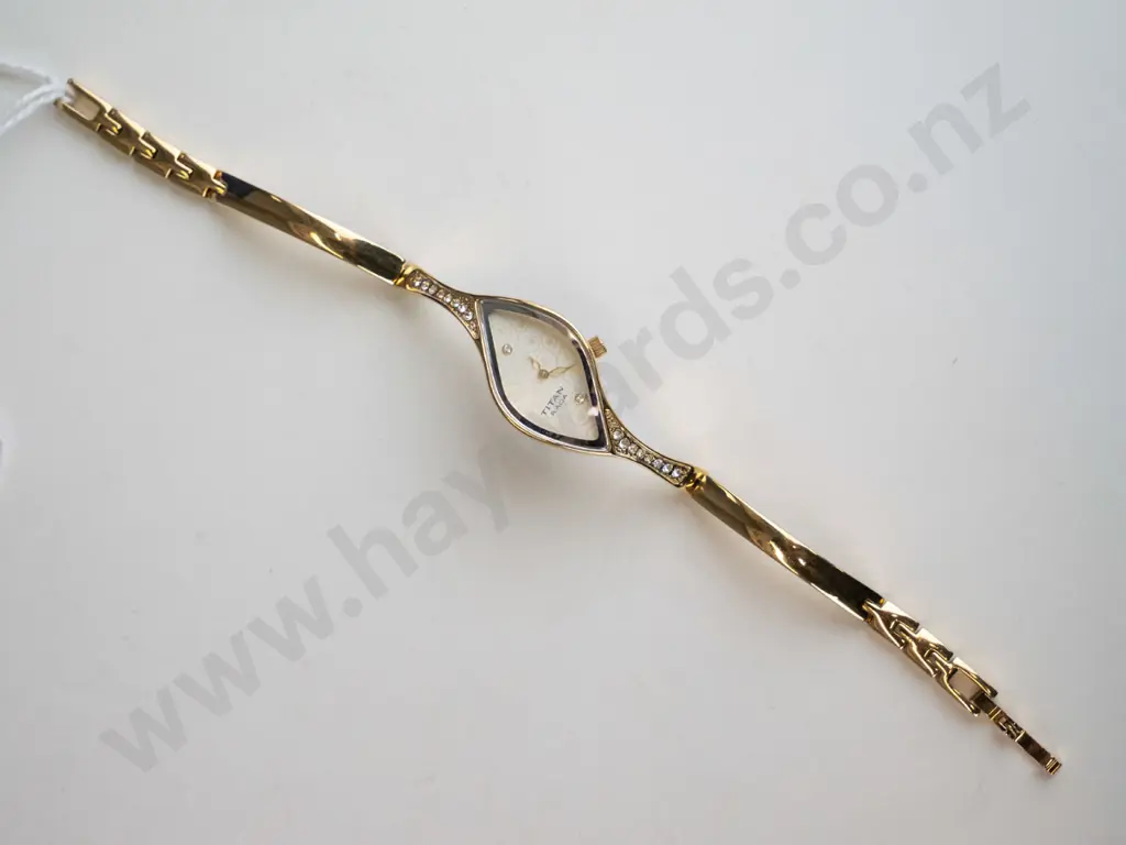 gold coloured diamond shaped watch with white stones Image 1++