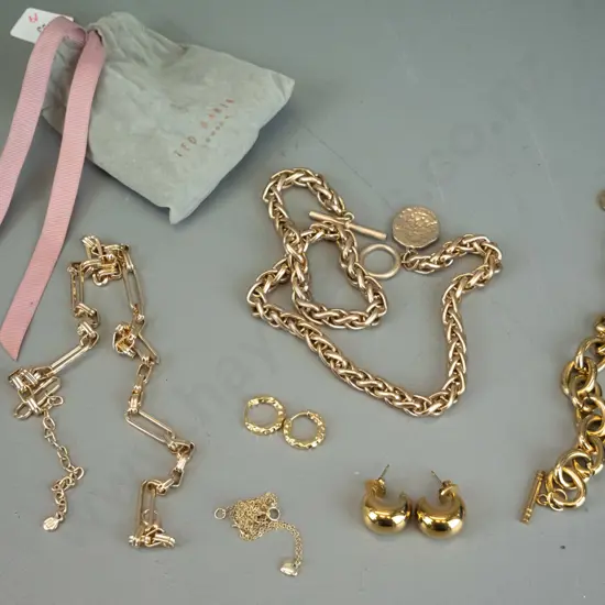 Gold jewellery in grey Ted Baker pouch