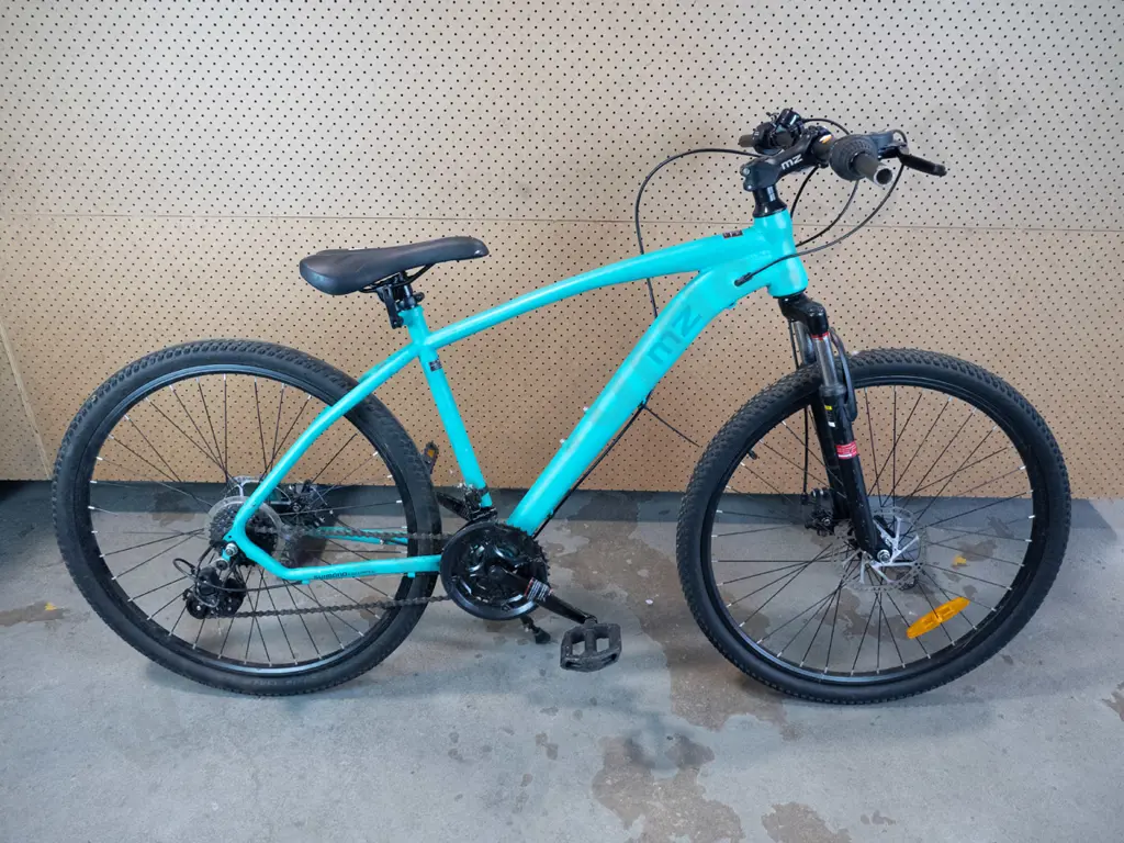 Aqua MZ bike with black seat and no handle bar grips. Image 1++