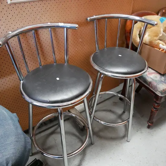 pair of chrome and black vinyl stool