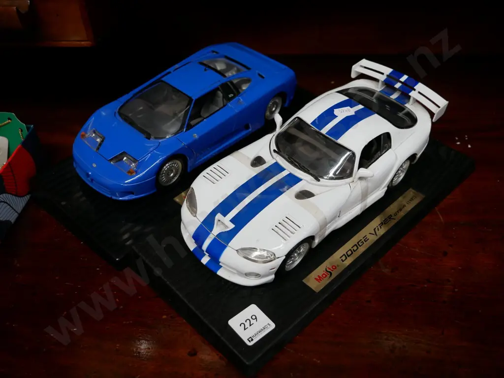 2 model vehicles on stands, Dodge Viper and Bugatti Image 1++