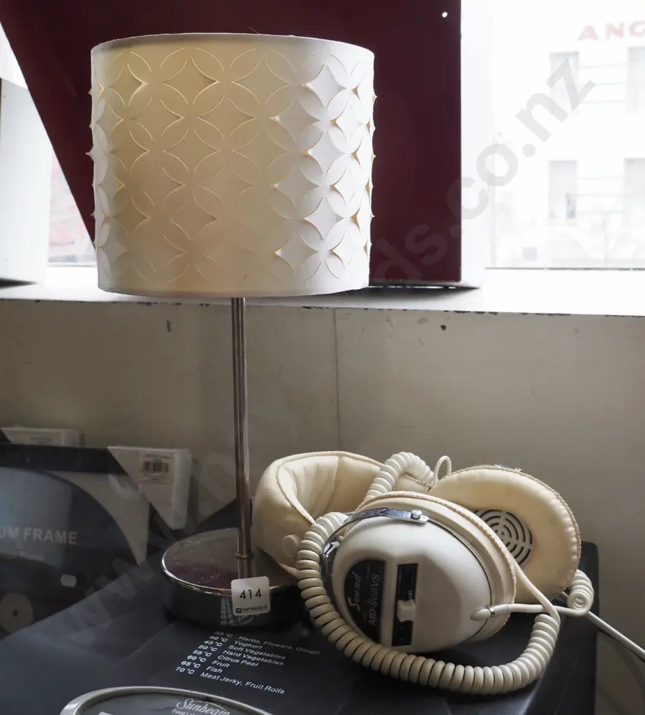 contemporary table lamp and pair of headphones Image 1++