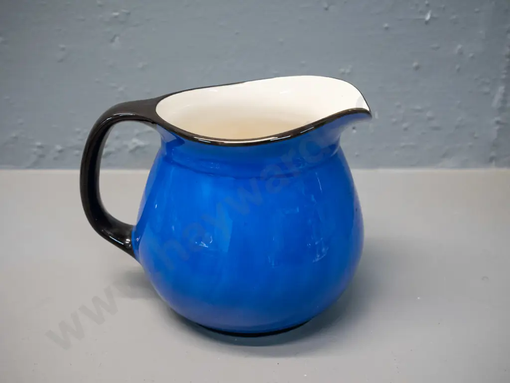 blue and black jug marked Crown Lynn and Catherine Anselmi Aotearoa NZ H-120 W-155 at handle Image 1++