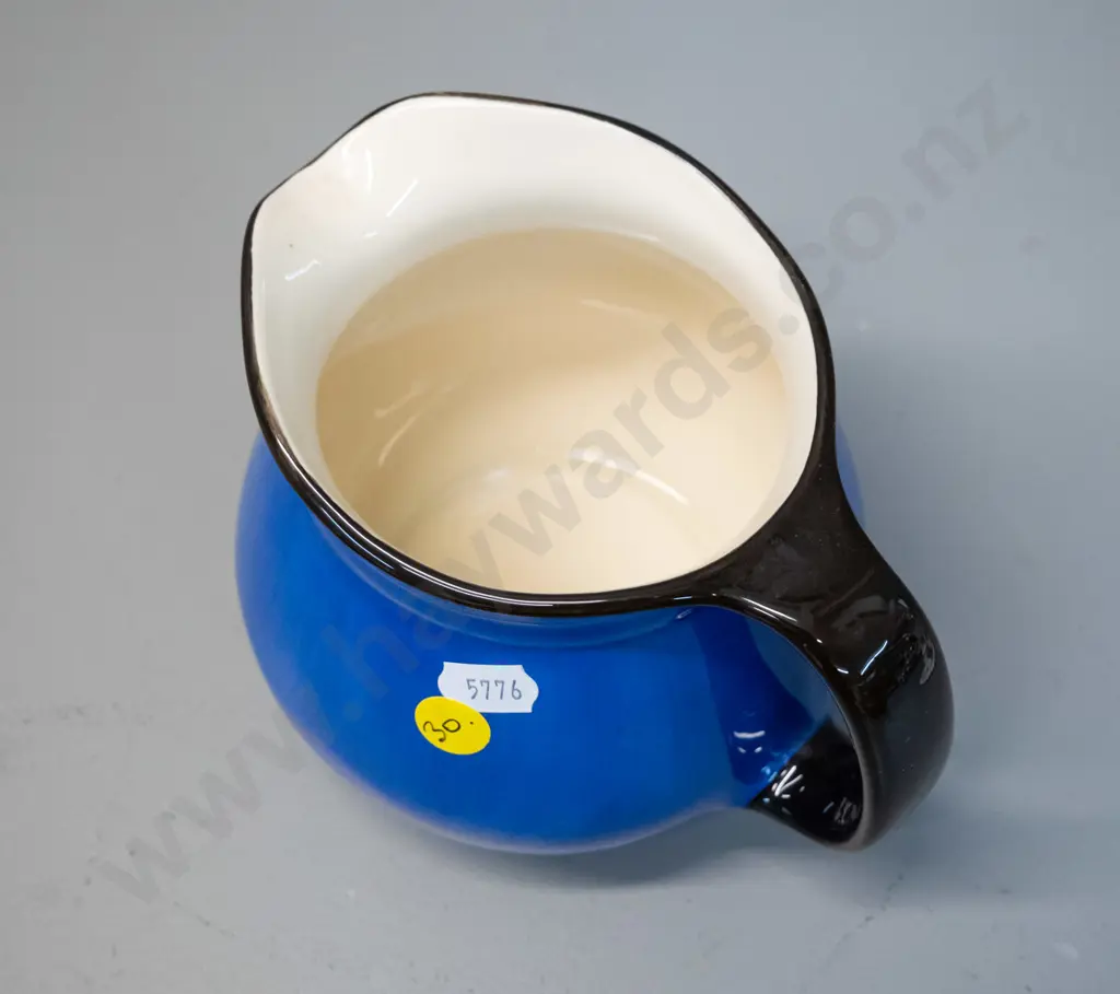 blue and black jug marked Crown Lynn and Catherine Anselmi Aotearoa NZ H-120 W-155 at handle Image 1++