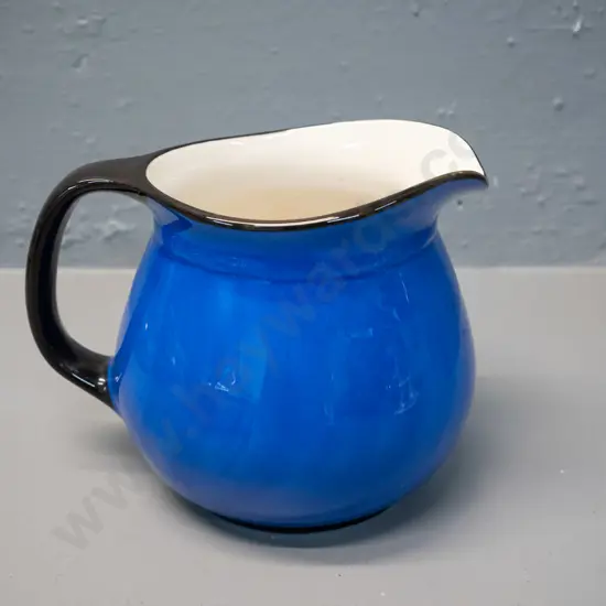 blue and black jug marked Crown Lynn and Catherine Anselmi Aotearoa NZ H-120 W-155 at handle