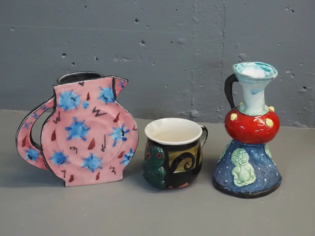 3 pieces New Zealand studio pottery - handled vase by Pink Paua / Liz Earth, tiki mug (unknown mark) and jug-shaped slab Image 1++