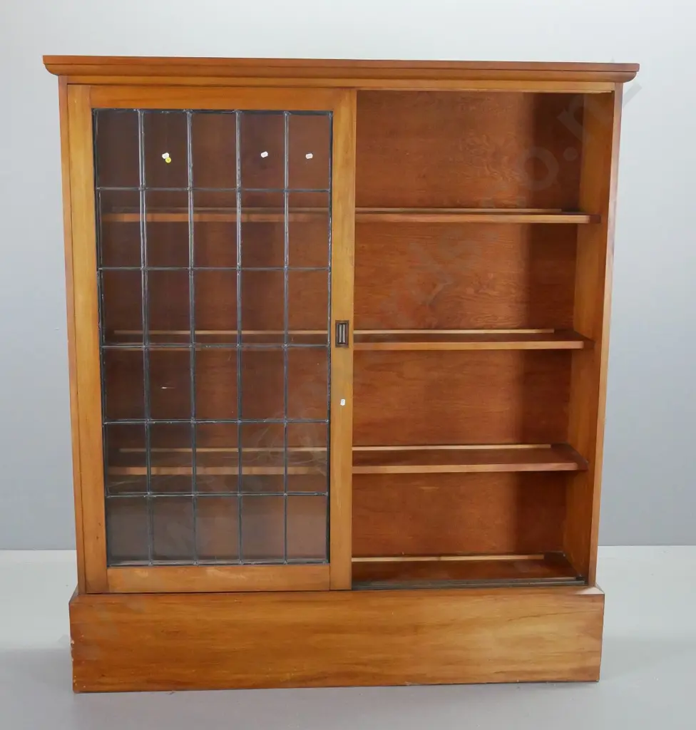 arts & crafts style rimu 3-shelf bookcase with 2 sliding leadlight doors, shaped cornice top and large plinth base. Image 1++