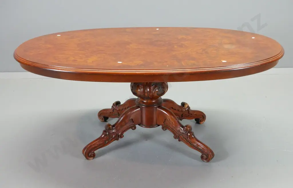 reproduction walnut oval coffee table with cross-banded edge, on carved 4-point pedestal base - wear to base H560 L1300 Image 1++