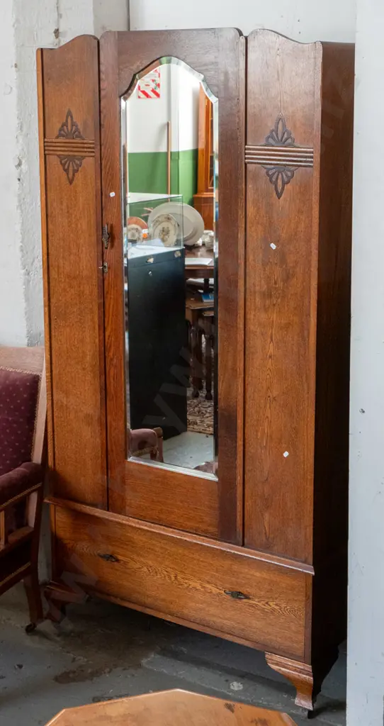 deco oak cab-leg single door wardrobe with oval bevelled edge mirror, single drawer, on casters. Some tape marks on door Image 1++