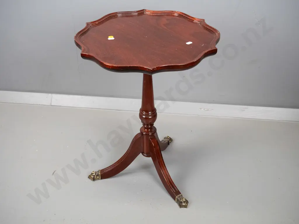 reproduction mahogany wine table with shaped moulded top, turned pedestal w/3 sweeping legs, brass paw feet H500 D400 Image 1++