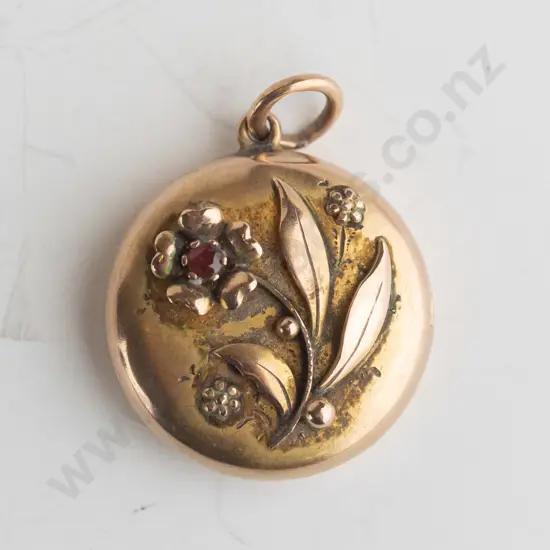 gold locket style pendant with ruby stamped 375,  no chain