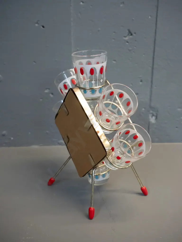 mid-century set of 6 shot-glasses in metal stand with mirrored back H-200 W-200 Slightly bent frame, one leg raised Image 1++