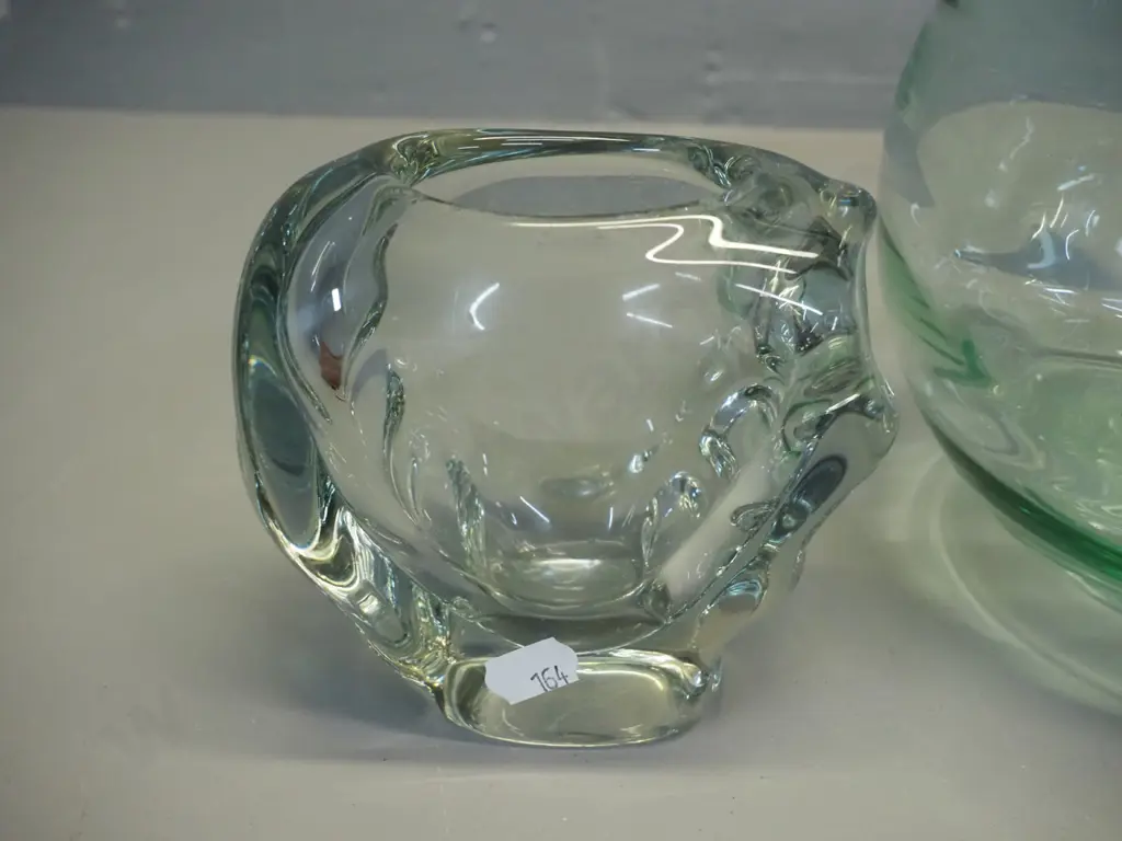 2 clear glass vases - large globe shaped H-210 D-220, and smaller heavy abstract shape. Larger has slight rough edge Image 1++