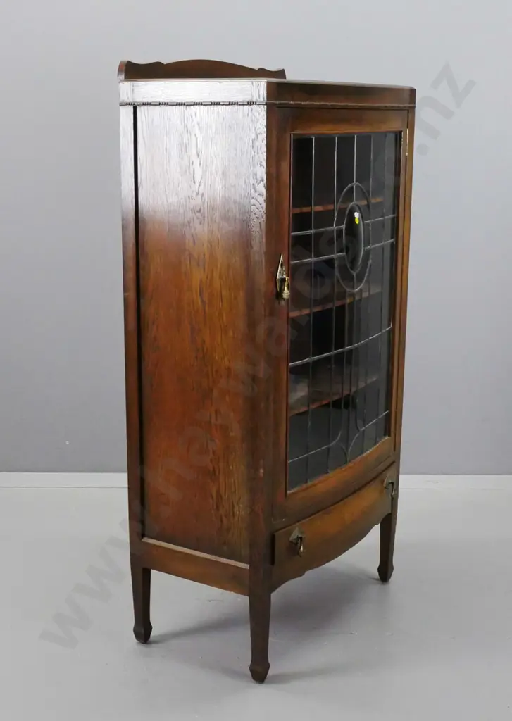 art deco oak bowed front display cabinet with leadlight door with oval slumped glass medallion, 3 fixed shelves, lower Image 1++