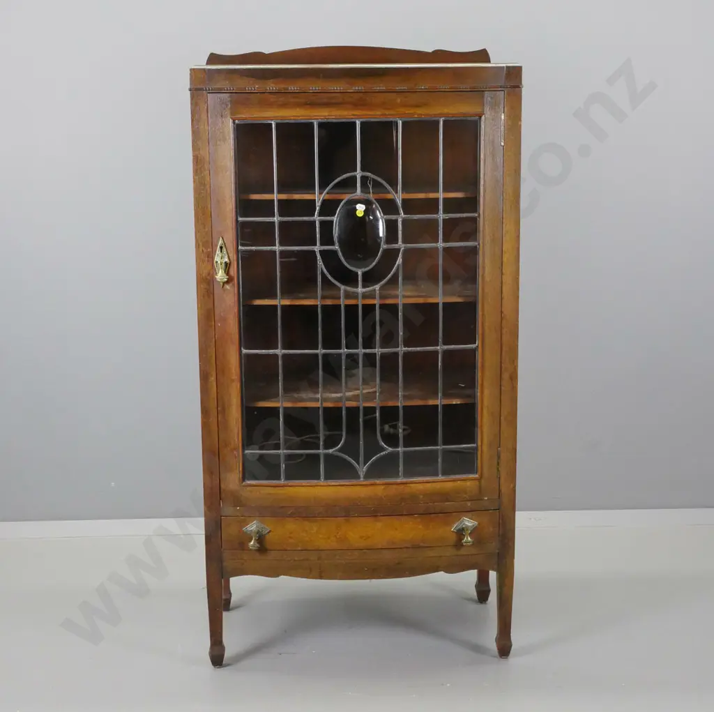 art deco oak bowed front display cabinet with leadlight door with oval slumped glass medallion, 3 fixed shelves, lower Image 1++