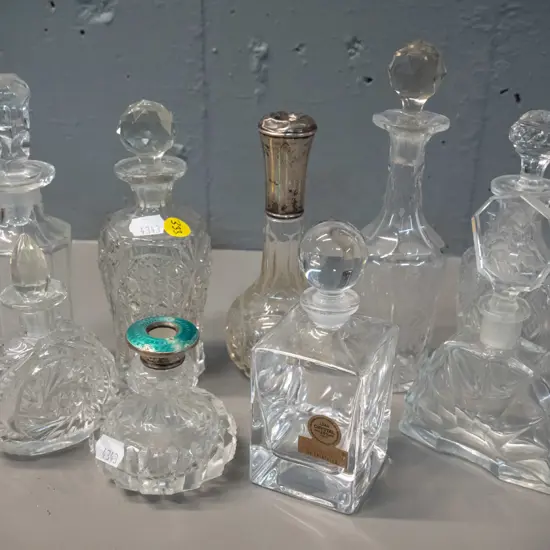 9 glass & lead crystal scent bottles, two with sterling silver collars, one w/ enamel, missing stoppers, a few w/ chips,