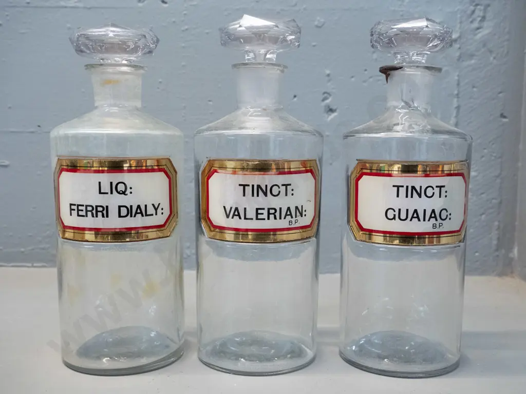 3 clear glass stoppered apothecary bottles with labels H-240 D-90 Image 1++