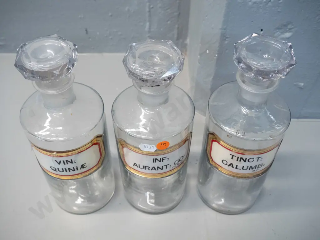 3 clear glass stoppered apothecary bottles with labels H-240 D-90 Image 1++
