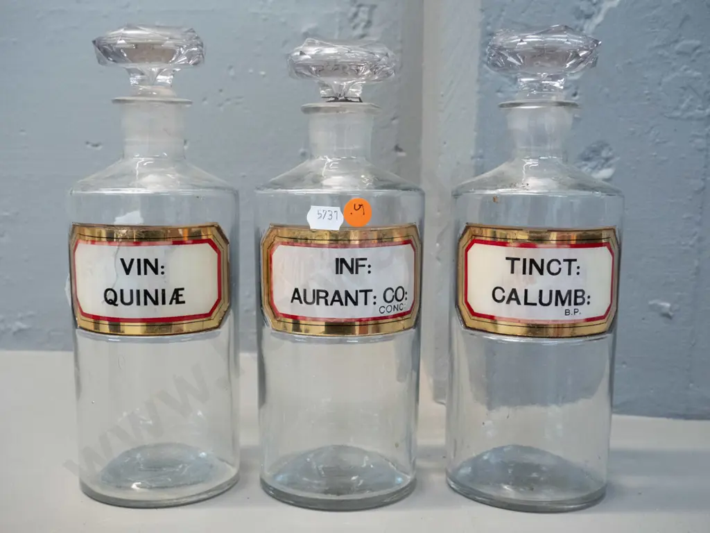 3 clear glass stoppered apothecary bottles with labels H-240 D-90 Image 1++