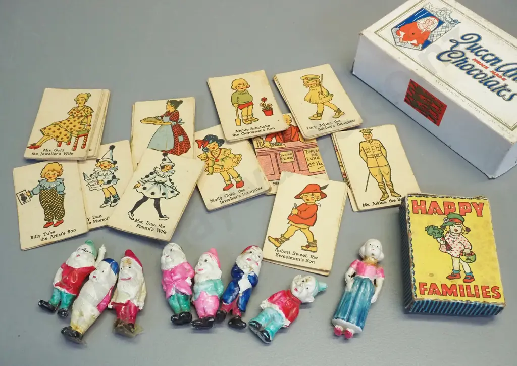 set of thin celluloid Snow White and 7 dwarves figures and a vintage Happy Families card game. Snow White has had repair Image 1++