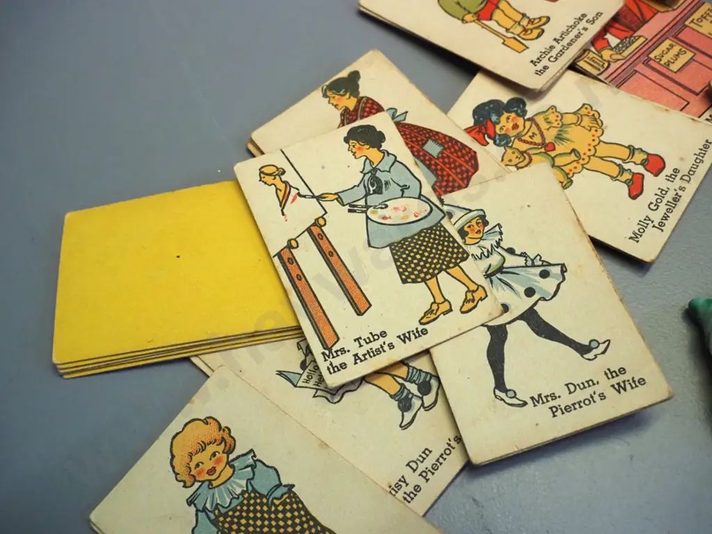 set of thin celluloid Snow White and 7 dwarves figures and a vintage Happy Families card game. Snow White has had repair Image 1++