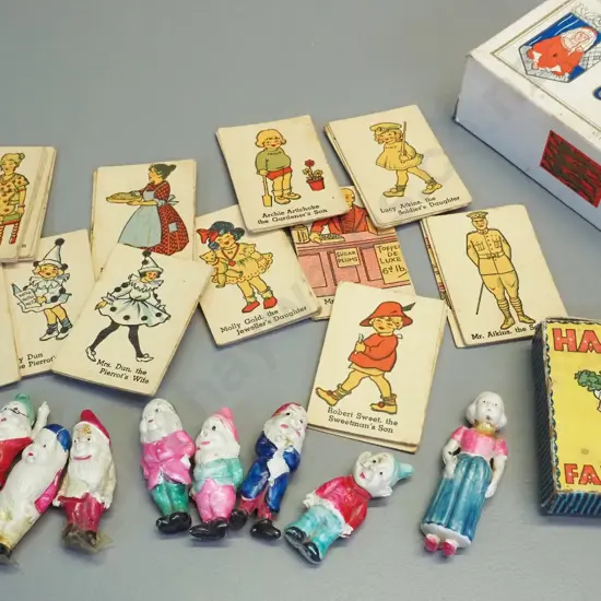 set of thin celluloid Snow White and 7 dwarves figures and a vintage Happy Families card game. Snow White has had repair