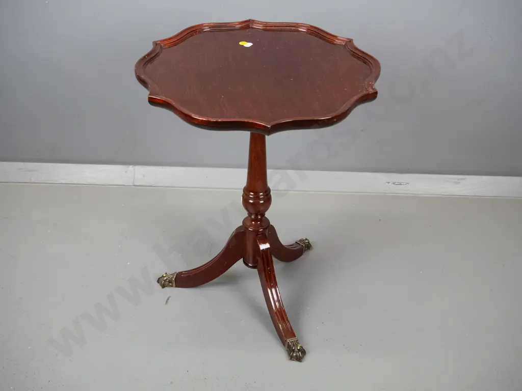reproduction mahogany wine table with shaped moulded top, turned pedestal w/3 sweeping legs, brass paw feet H500 D400 Image 1++