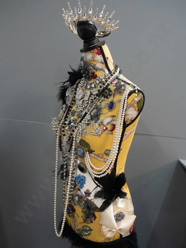 fabric covered timber-based dressmaker's form / mannequin decorated with braid, feathers, and numerous pieces of costume Image 1++