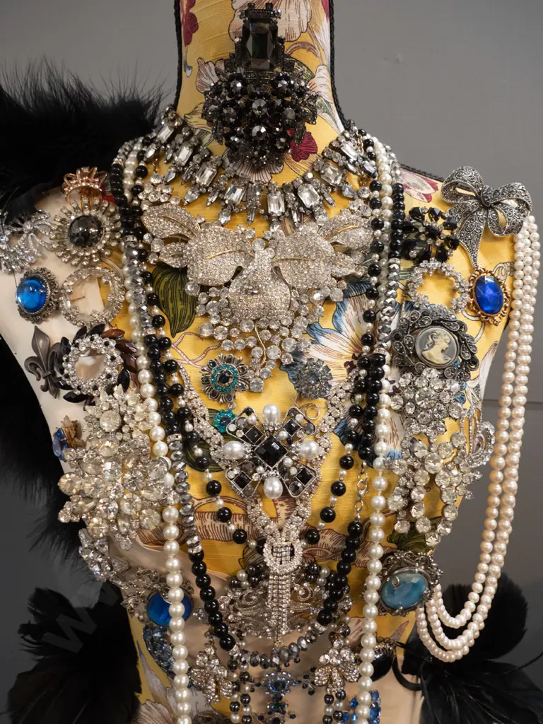 fabric covered timber-based dressmaker's form / mannequin decorated with braid, feathers, and numerous pieces of costume Image 1++