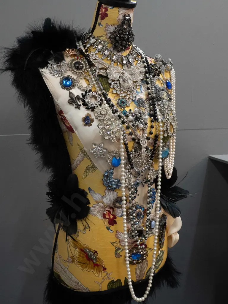 fabric covered timber-based dressmaker's form / mannequin decorated with braid, feathers, and numerous pieces of costume Image 1++