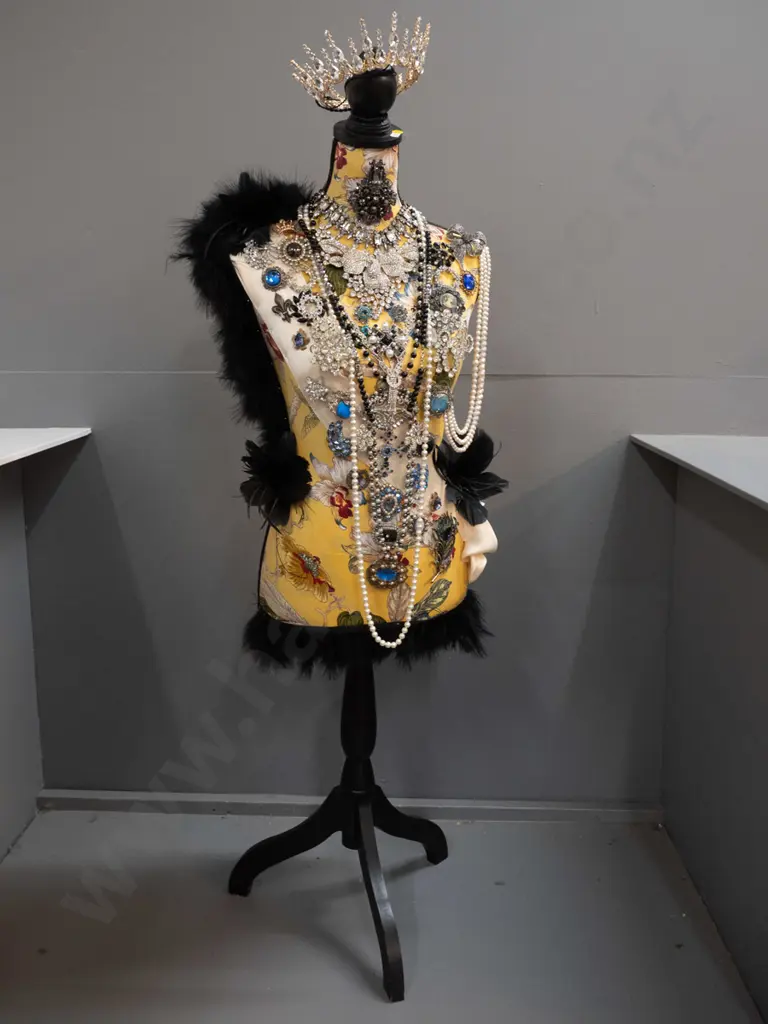 fabric covered timber-based dressmaker's form / mannequin decorated with braid, feathers, and numerous pieces of costume Image 1++