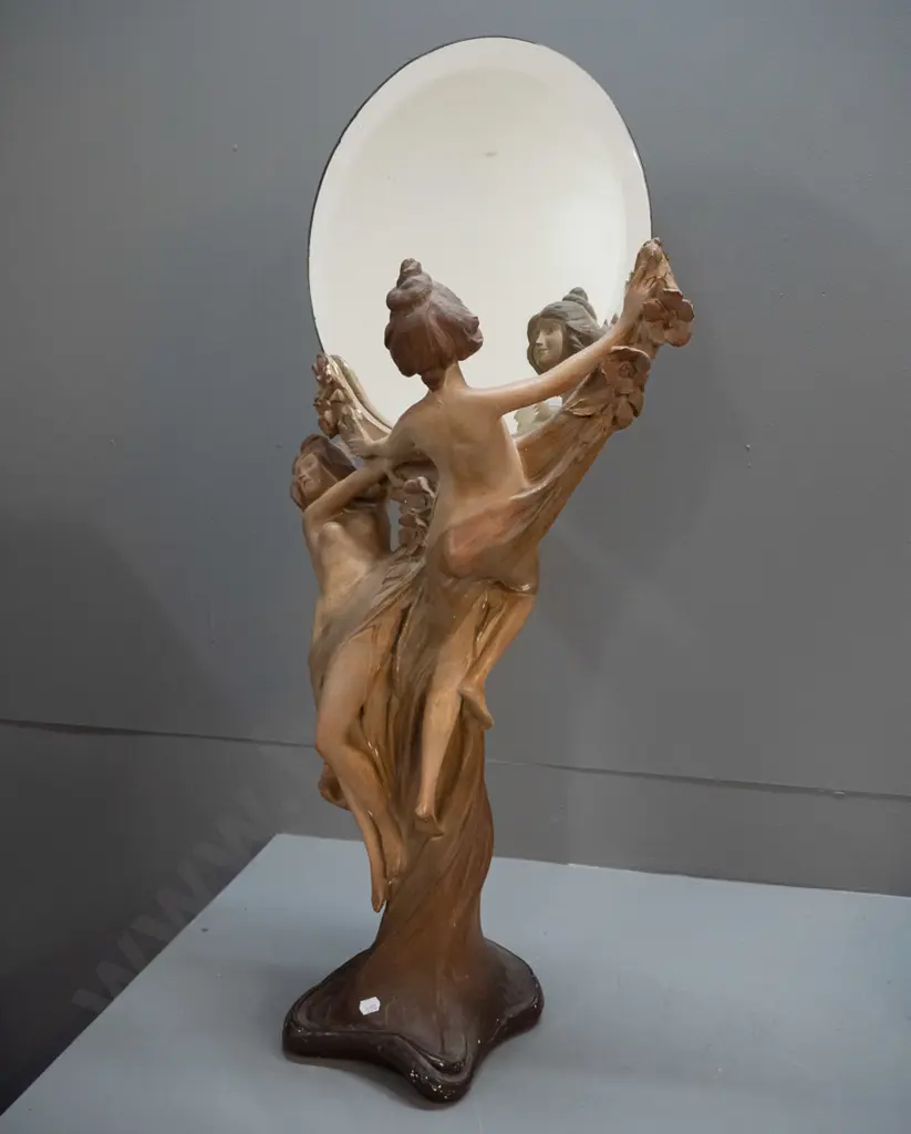 nouveau style porcelain figurine of two women holding round bevelled mirror, on NZ mixed timber pedestal. Some glaze Image 1++