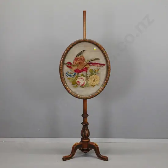 Victorian walnut adjustable pole-screen with oval carved frame, embroidered bird and flower panel, column base with