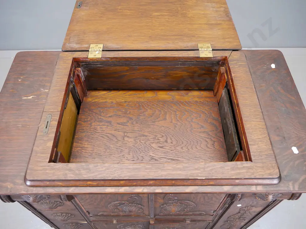 oak cupboard with lift up lid above two sets of central cupboard doors, flanked by five small drawers on one side Image 1++