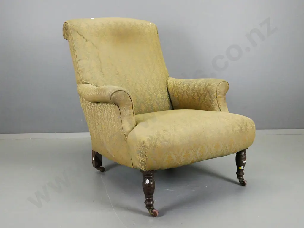 Edwardian rolled-arm fireside chair with turned front legs, porcelain casters, gold & green fabric has wear and needs Image 1++