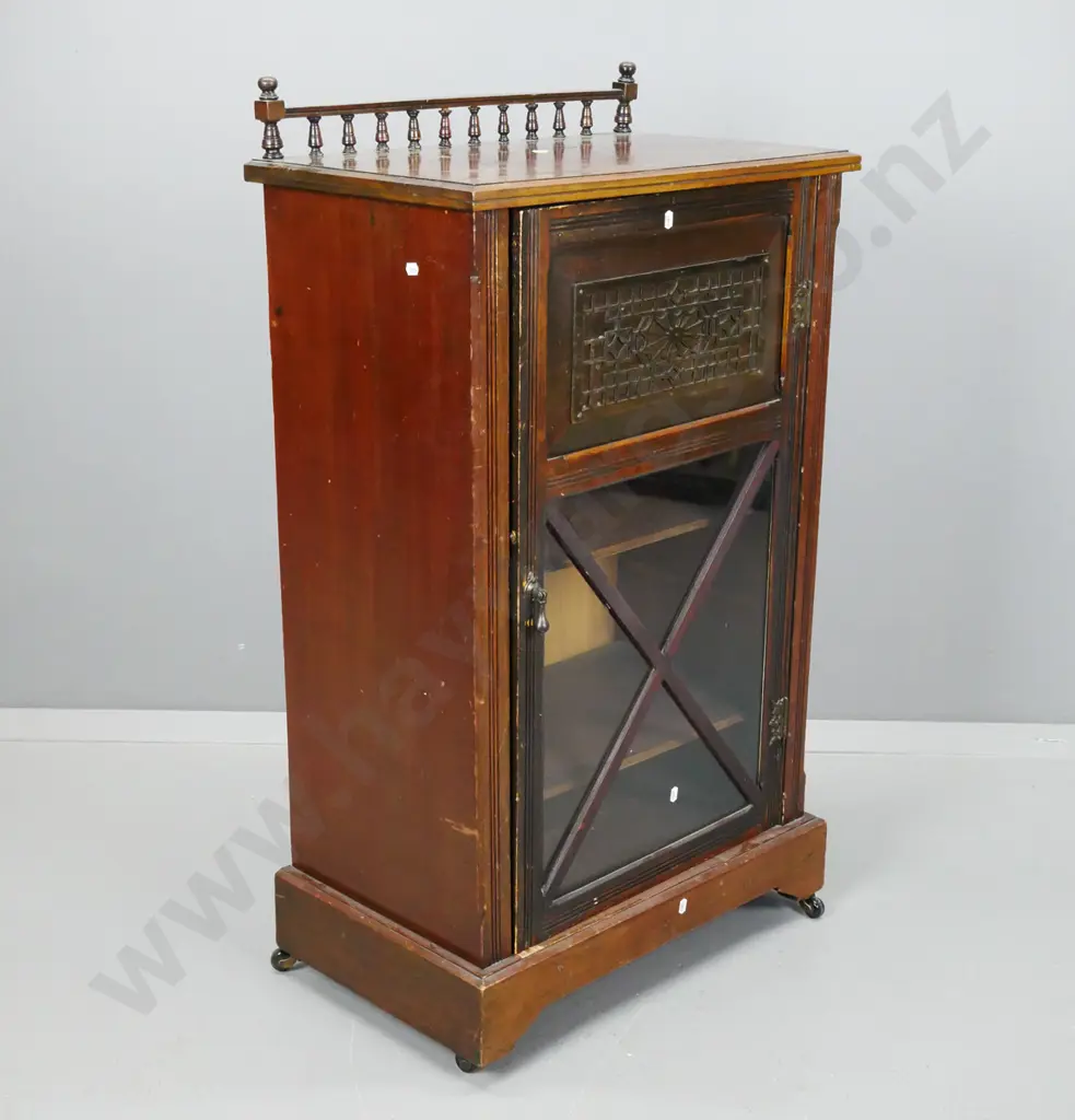 Edwardian music canterbury w/ turned back rail, carved frieze and x-frame glazed door, 3 shelves, drop handle, on plinth Image 1++