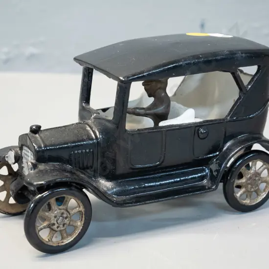 cast metal vintage car painted black white and silver, with separate unpainted peg-fit driver - H-100 L-160