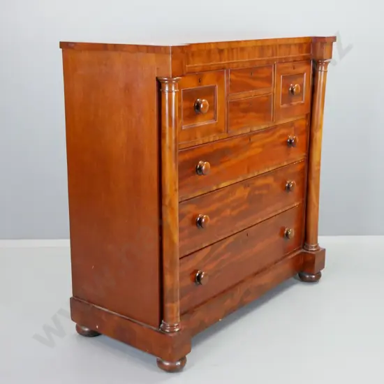 Victorian mahogany 7 drawer chest, all lockable, 2 have no knobs, has key. Turned pilasters, bun feet. Scratches to top.