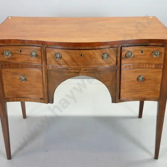 Regency mahogany serpentine fronted sideboard w/3 drawers with ring handles, square tapered legs - remnants of BADA seal