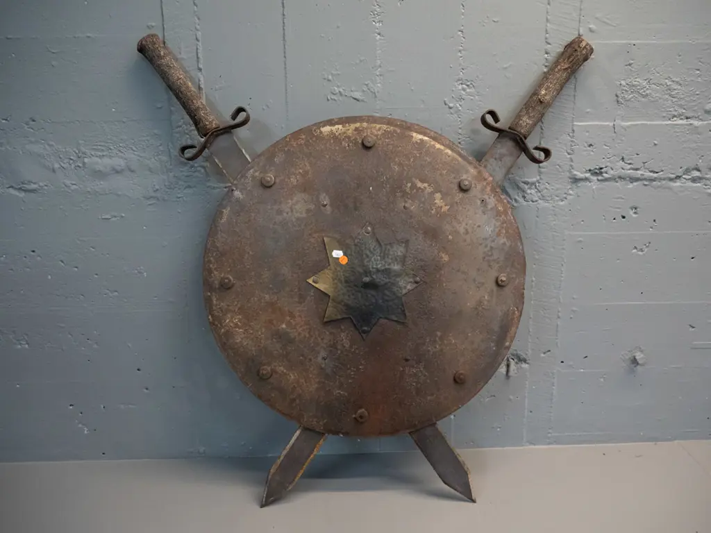 decorative shield and crossed swords - iron with beaten brass star, timber tree branch handles H-800 W-760 Image 1++