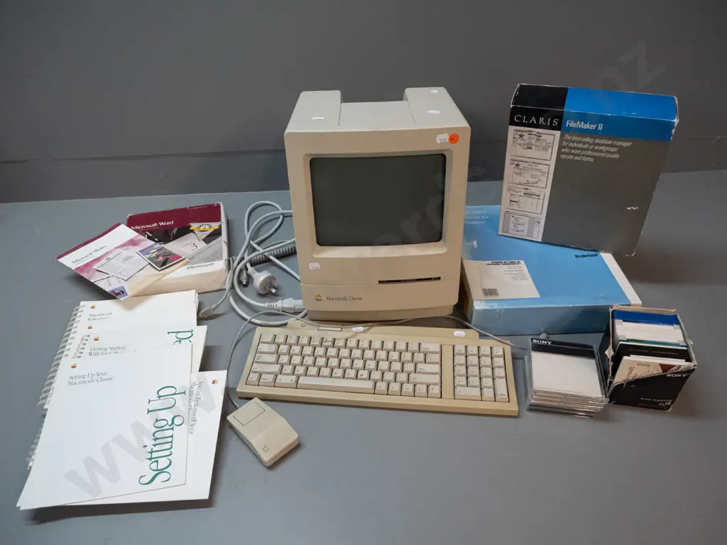circa 1990 Apple Macintosh Classic model M0420 computer with keyboard, mouse, assorted software, diskettes, etc. Image 1++