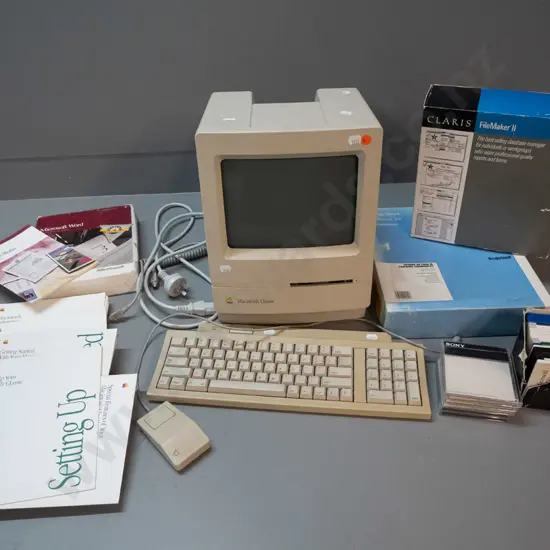 circa 1990 Apple Macintosh Classic model M0420 computer with keyboard, mouse, assorted software, diskettes, etc.