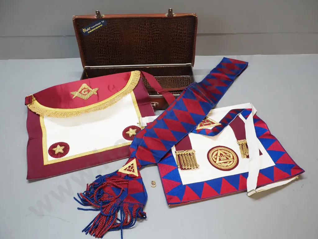 lodge regalia in small leather case - 2 aprons, sash and small pin. Some corrrosion to metal fittings on case, some wear Image 1++