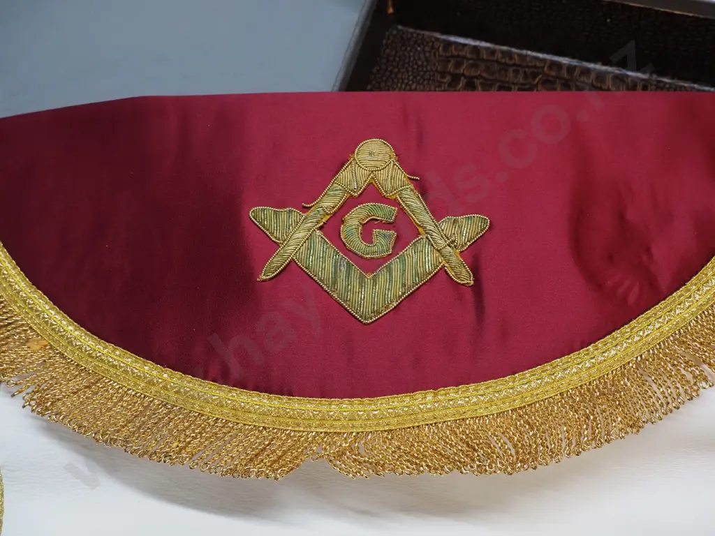 lodge regalia in small leather case - 2 aprons, sash and small pin. Some corrrosion to metal fittings on case, some wear Image 1++