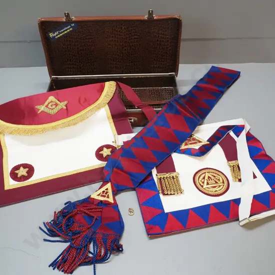 lodge regalia in small leather case - 2 aprons, sash and small pin. Some corrrosion to metal fittings on case, some wear