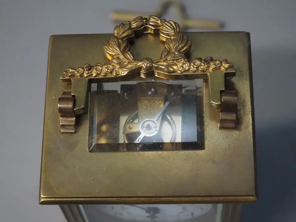 small heavy brass and glass carriage clock with key - no maker's mark, lion emblem on back. H-125 W-75 D65 Image 1++