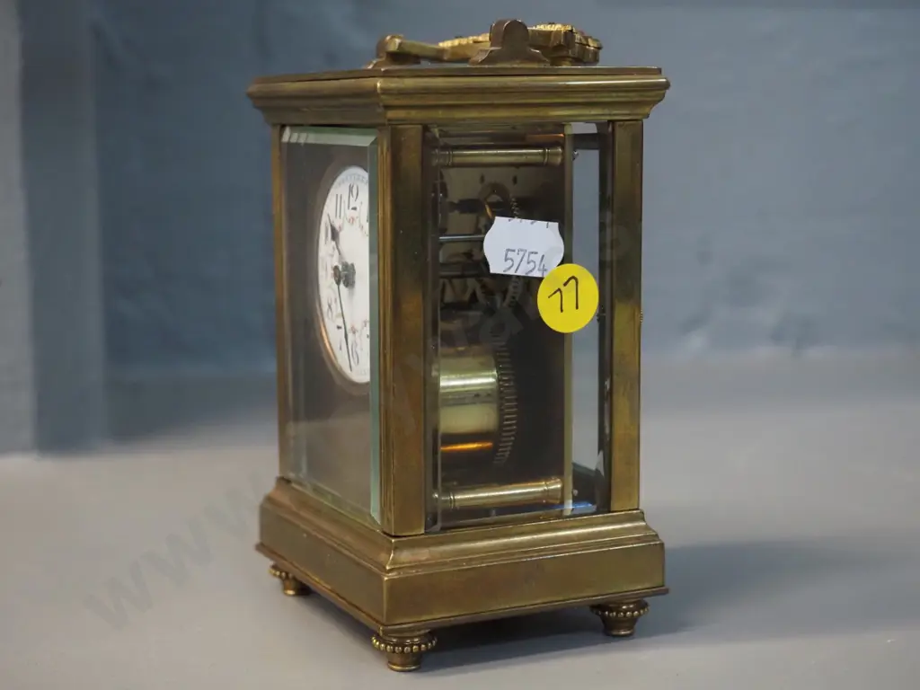 small heavy brass and glass carriage clock with key - no maker's mark, lion emblem on back. H-125 W-75 D65 Image 1++