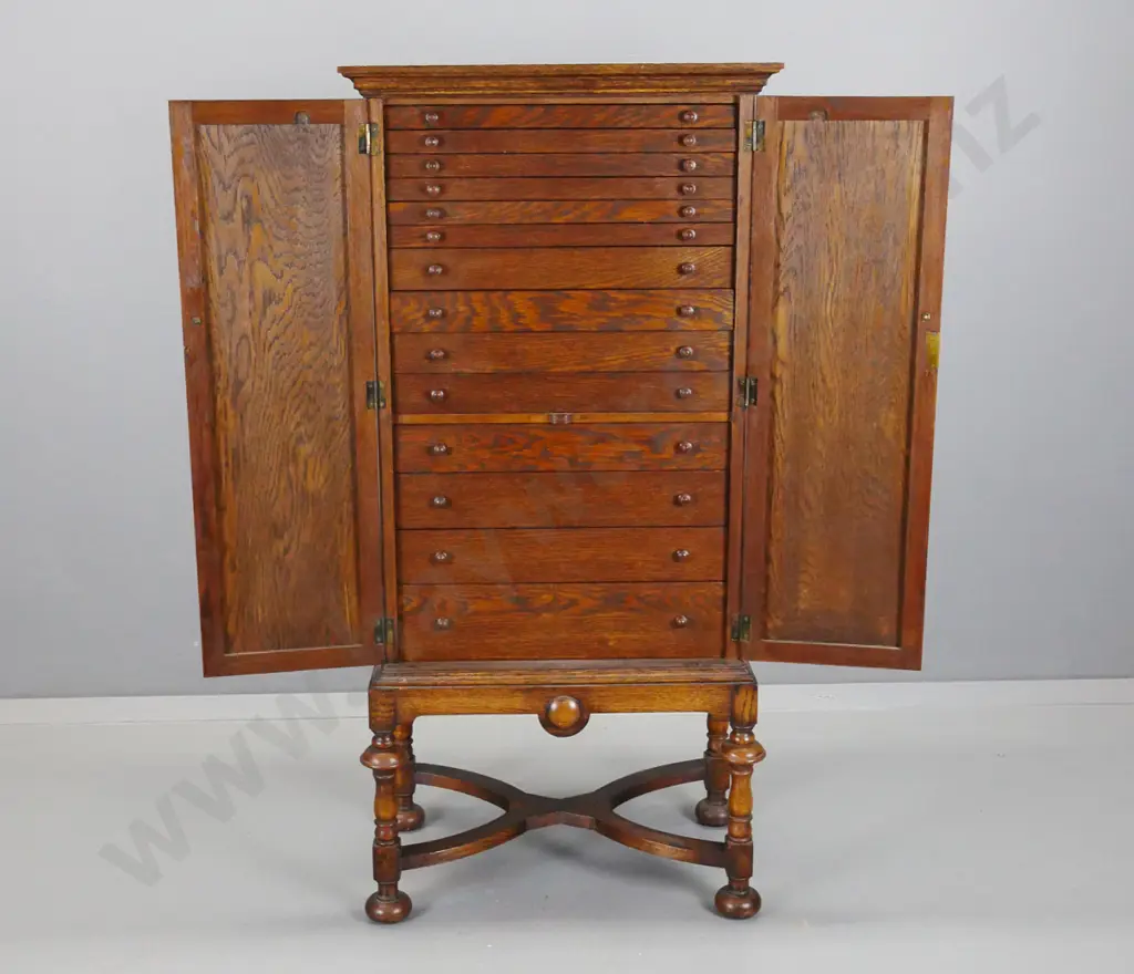 vintage oak cabinet with 2 panelled doors w/ drop handles, 14 interior drawers. some with partitions, panelled sides, on Image 1++