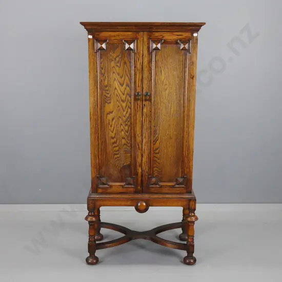 vintage oak cabinet with 2 panelled doors w/ drop handles, 14 interior drawers. some with partitions, panelled sides, on