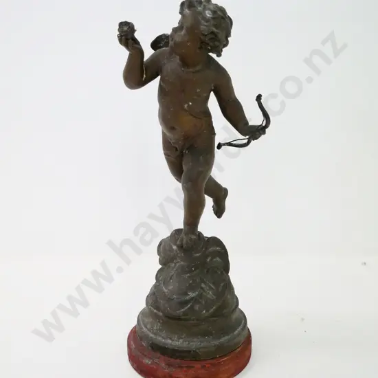 metal cupid figure on wooden base - damage to back, missing wing. H-340